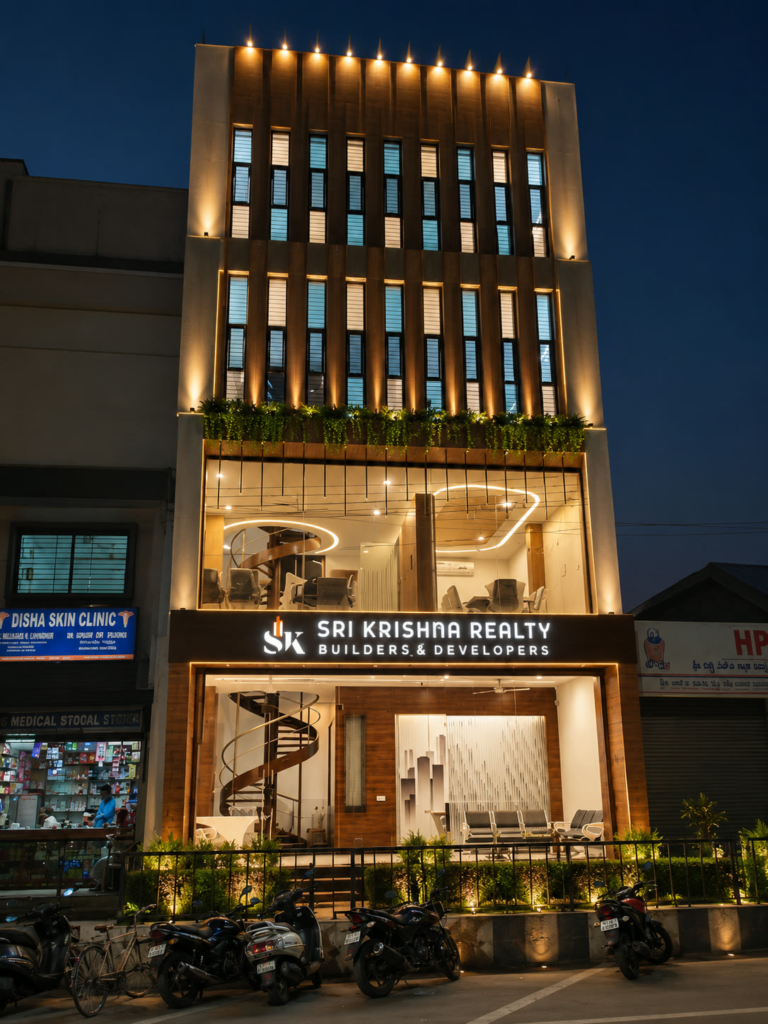 Sri Krishna Realty Builders & Developers office on M G Road, Vijayapura, lit up at night