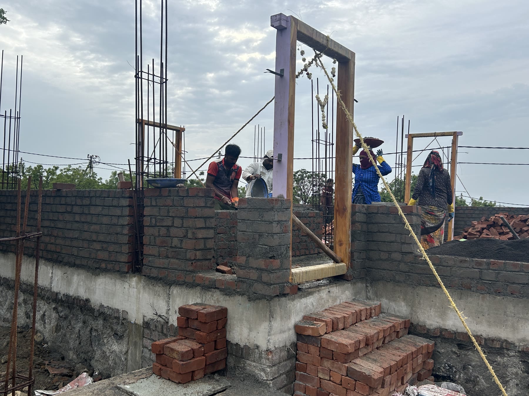Reinforced concrete columns and formwork at an active Sri Krishna Realty construction site