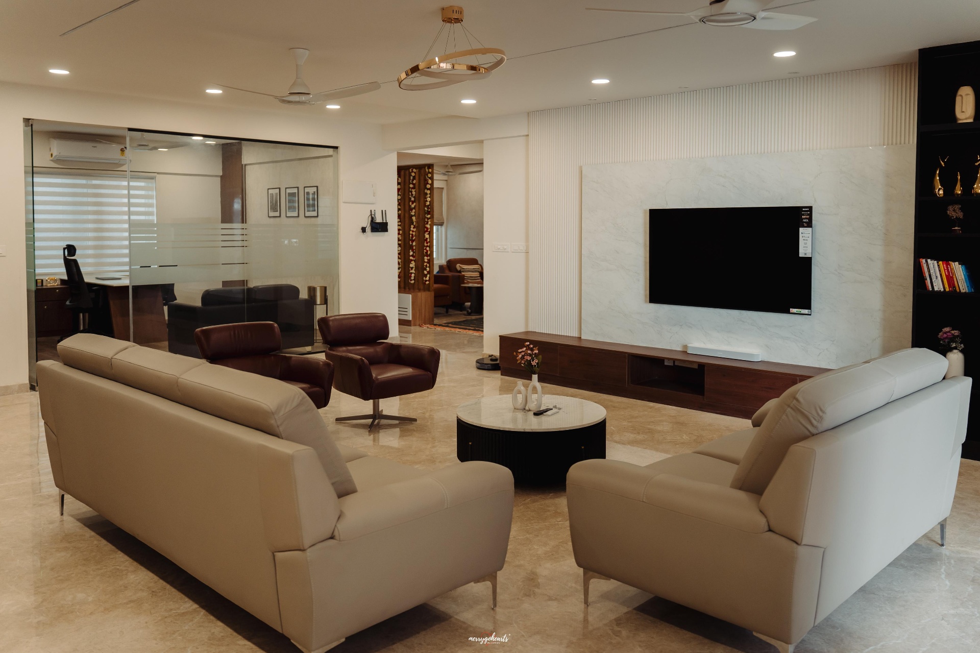 Open living area connected to a glass-partitioned home office