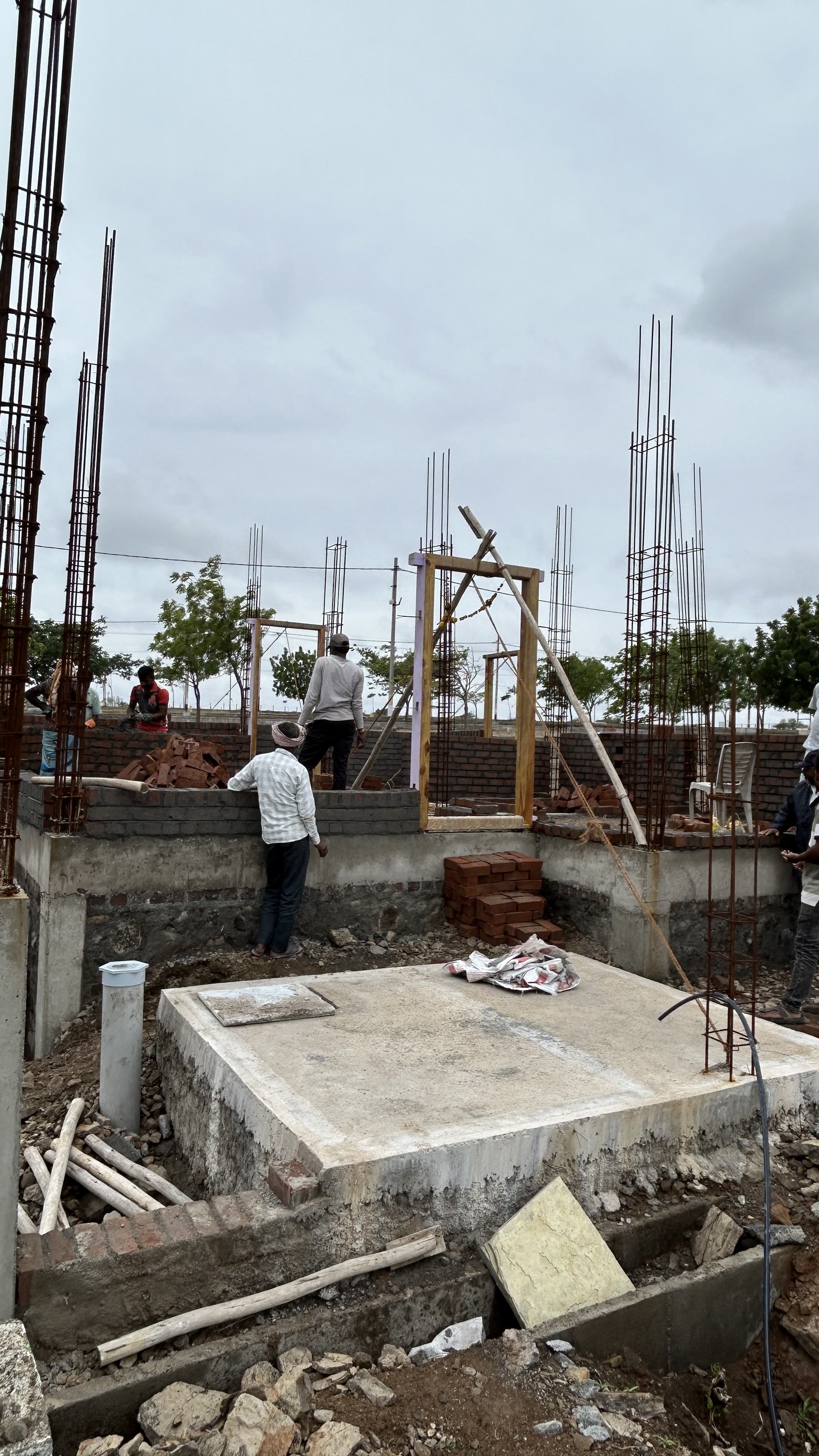 Brick masonry walls being raised on a house under construction
