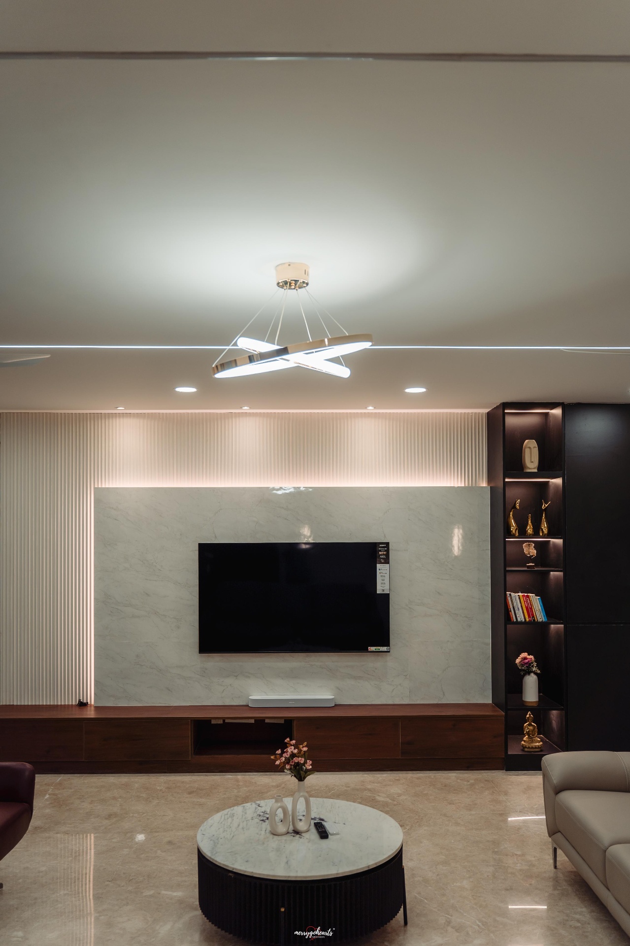 Completed living room with marble TV feature wall and fluted panelling